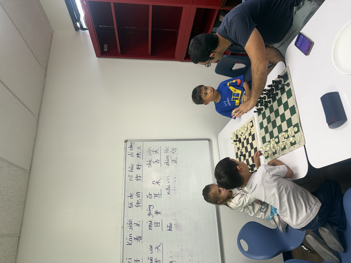A coach teaching young students at the board