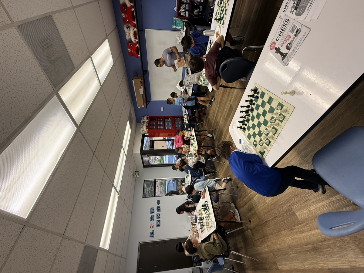 A student leaning over the board during a weekly class