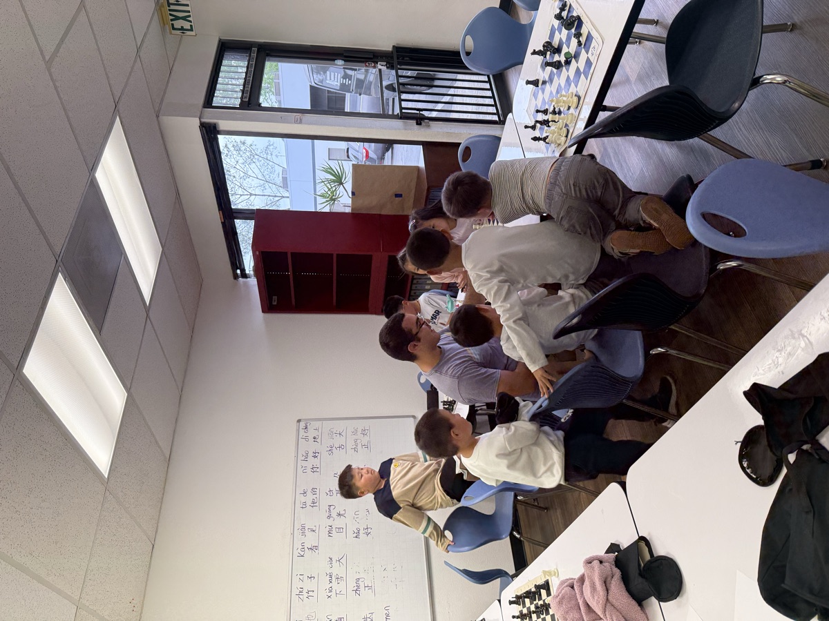 A coach helping a group of young students during a lesson