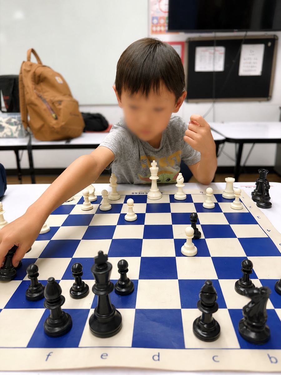 A student reaching to move a piece during a lesson