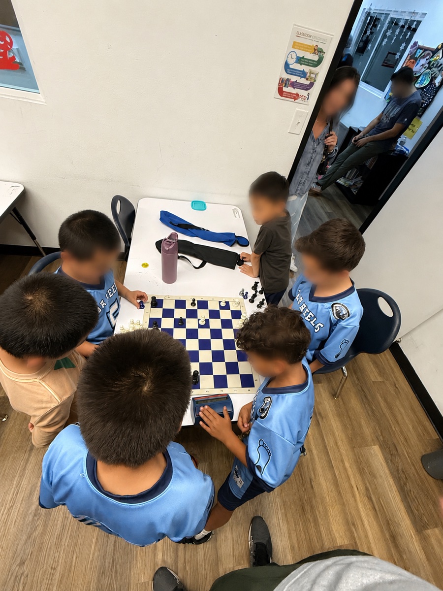 Students and a coach at the chess tables